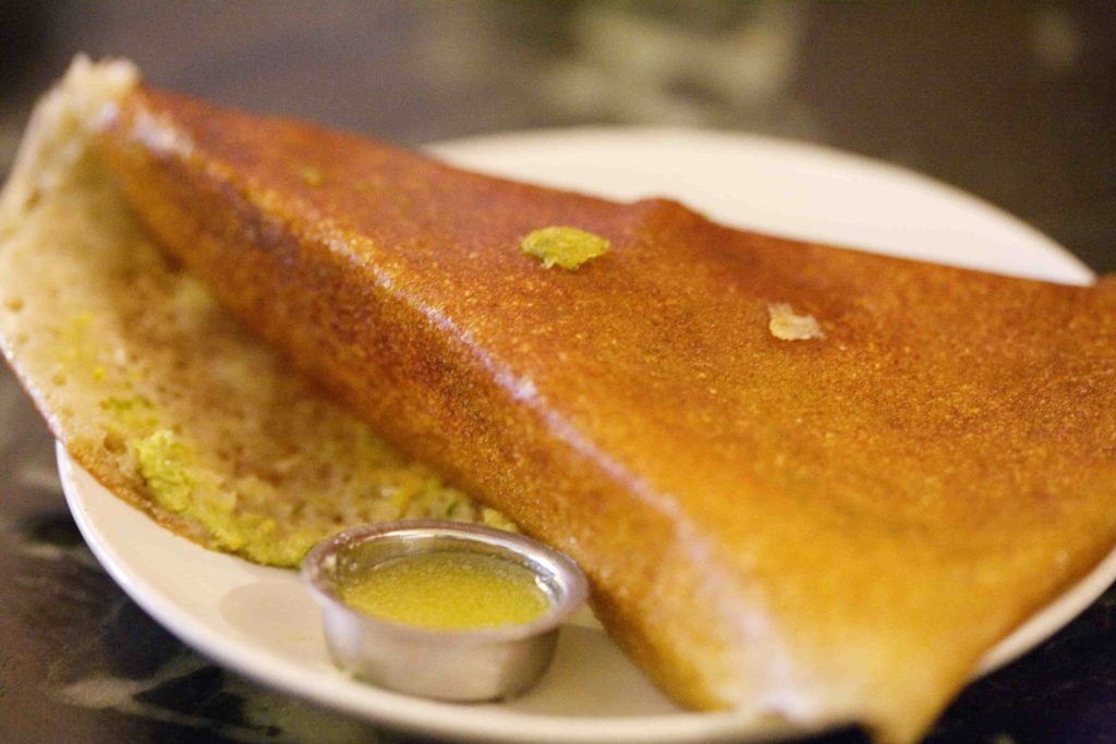 Adding ghee to dosa. Ghee benefits